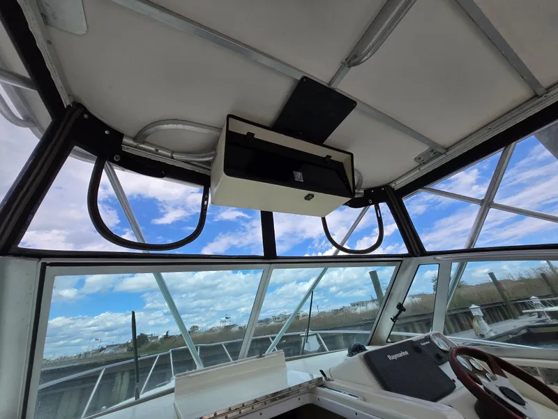 Slide: The Image of 2001 Pursuit 2860 Denali boat interior with clear sky view through windows. - 14
