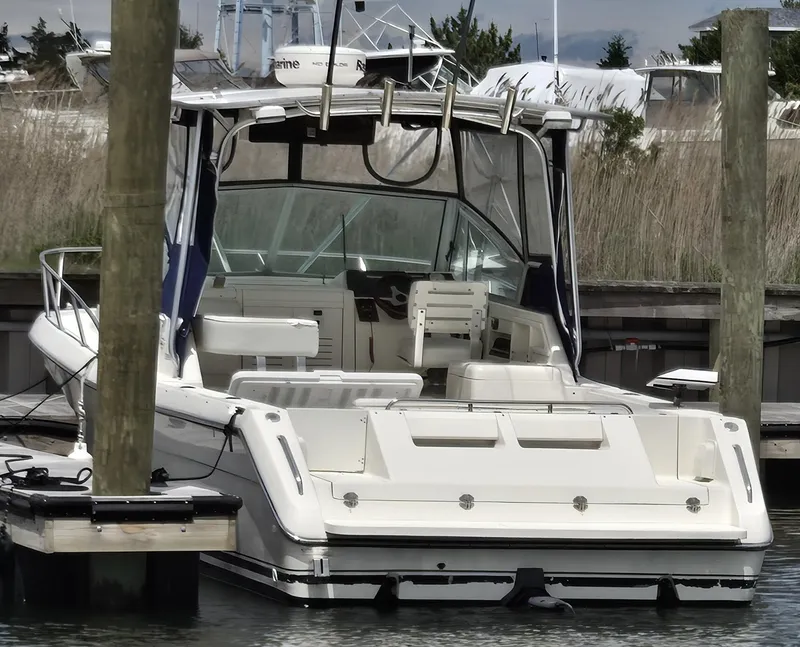 Slide: The Image of 2001 Pursuit 2860 Denali boat docked at marina, rear view. - 16