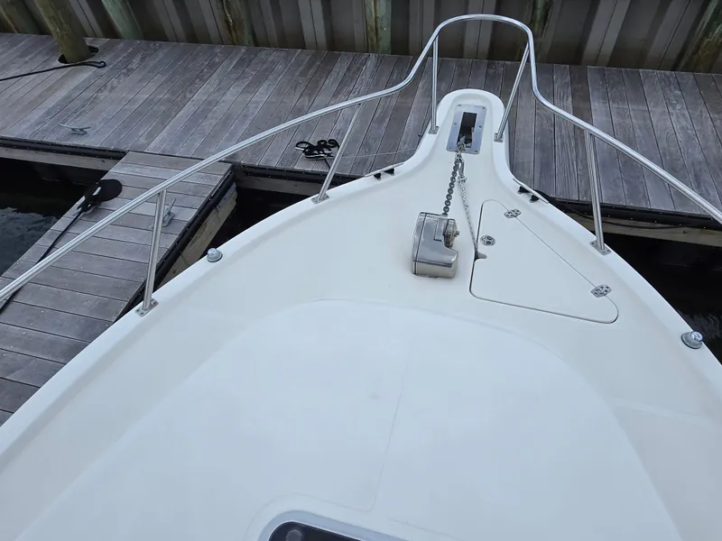 Slide: The Image of Bow of 2001 Pursuit 2860 Denali boat docked at wooden pier. - 20