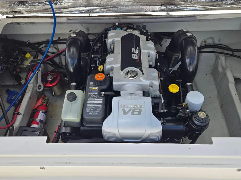 Slide: The Image of Engine compartment of a 2001 Pursuit 2860 Denali boat, featuring a powerful V8 engine. - 3