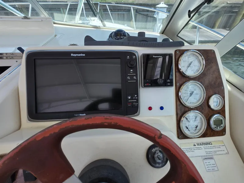 Slide: The Image of 2001 Pursuit 2860 Denali boat dashboard with steering wheel and navigation instruments. - 4