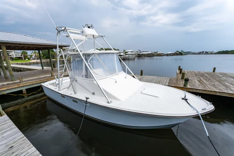Slide: The Image of 1978 Topaz 28 boat docked at a marina under cloudy skies. - 10