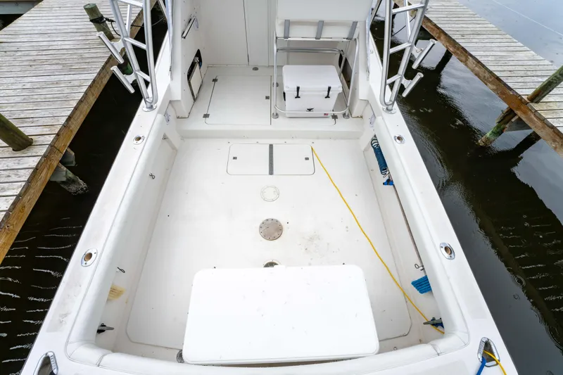 Slide: The Image of 1978 Topaz 28 boat interior, spacious deck, docked by wooden piers. - 11