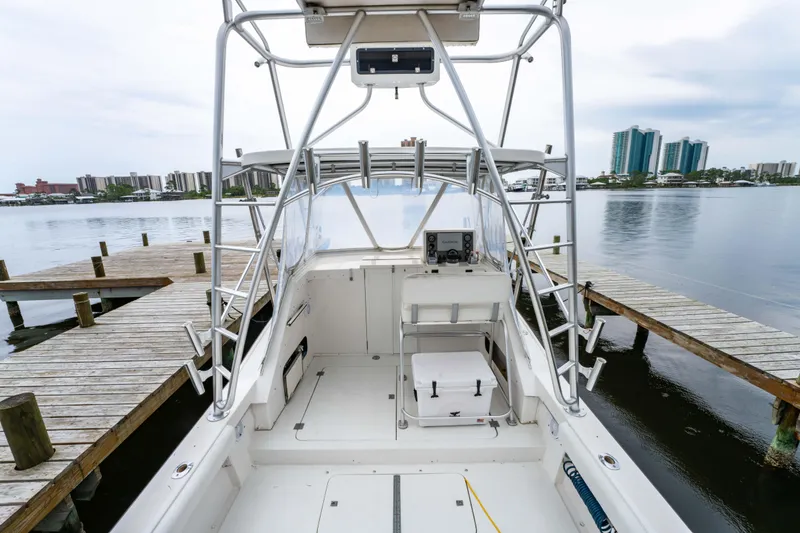 Slide: The Image of 1978 Topaz 28 boat docked at marina with city skyline in background. - 12