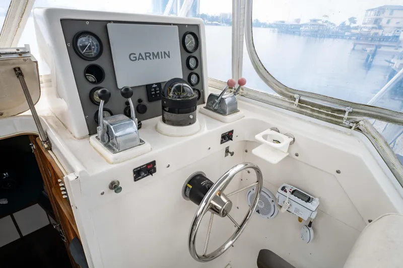 Slide: The Image of Helm of 1978 Topaz 28 boat with Garmin navigation system and steering wheel. - 14
