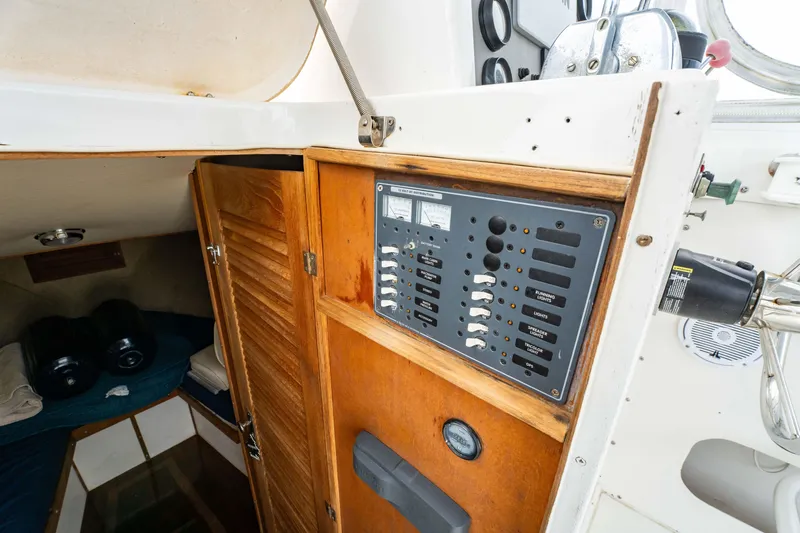 Slide: The Image of Interior of 1978 Topaz 28 boat showing control panel and cabin area. - 16