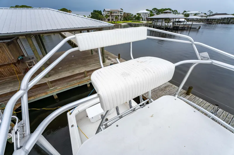 Slide: The Image of 1978 Topaz 28 boat with white seating, docked near waterfront buildings. - 18