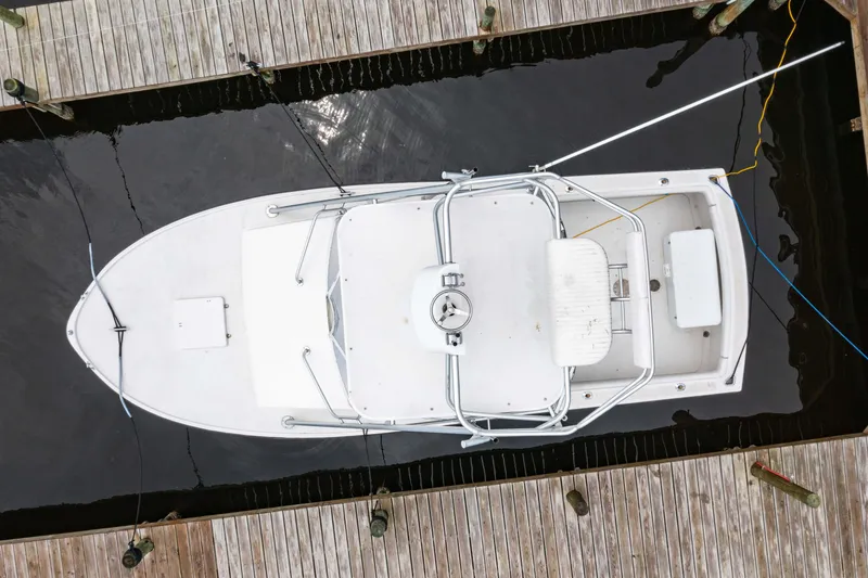 Slide: The Image of Aerial view of a 1978 Topaz 28 boat docked between wooden piers. - 2