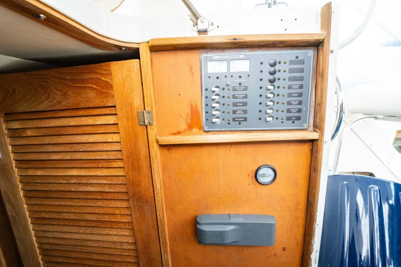 Slide: The Image of Wooden control panel on a 1978 Topaz 28 boat interior. - 21