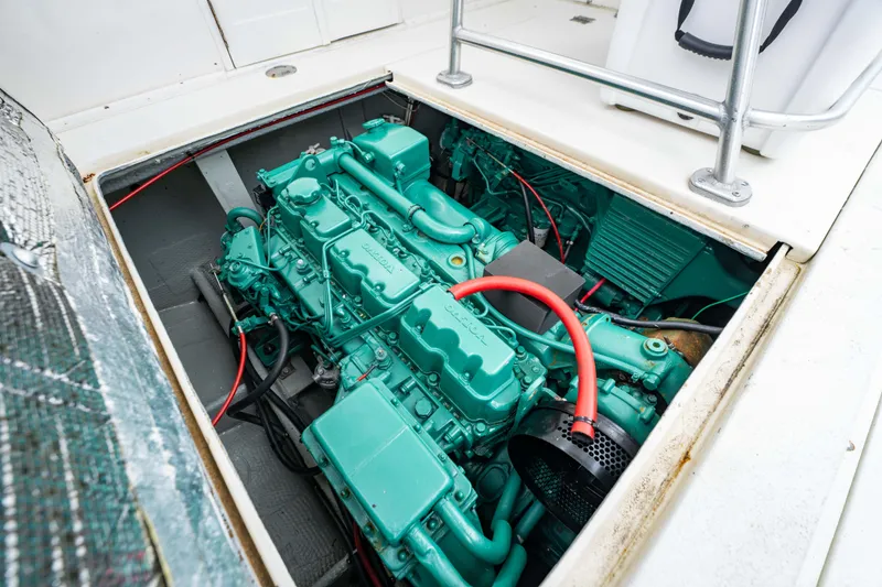 Slide: The Image of Engine compartment of a 1978 Topaz 28 boat, showcasing a green marine engine. - 23