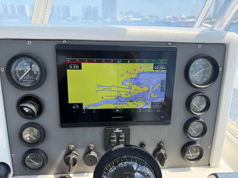 Slide: The Image of Dashboard of a 1978 Topaz 28 boat with navigation display and gauges. - 24