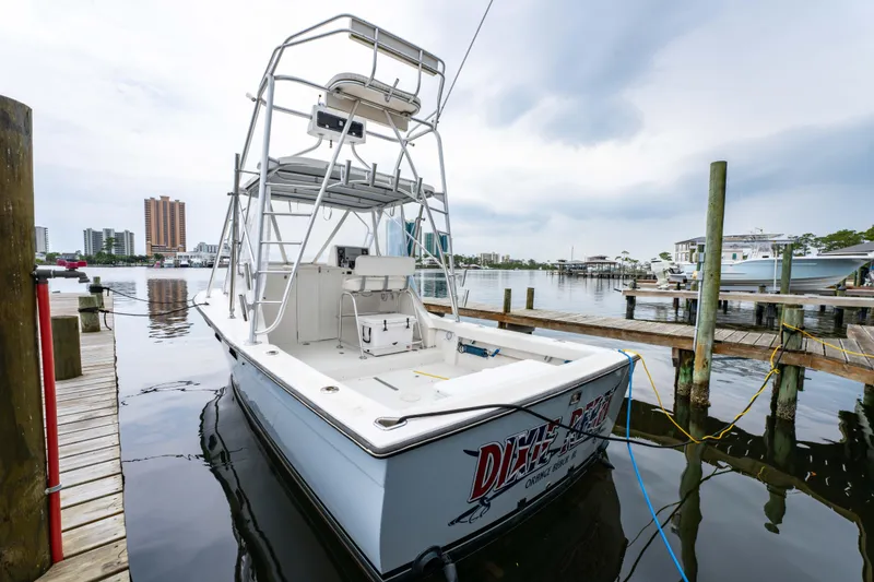 Slide: The Image of 1978 Topaz 28 boat docked in marina, featuring a tall tower and open deck. - 5
