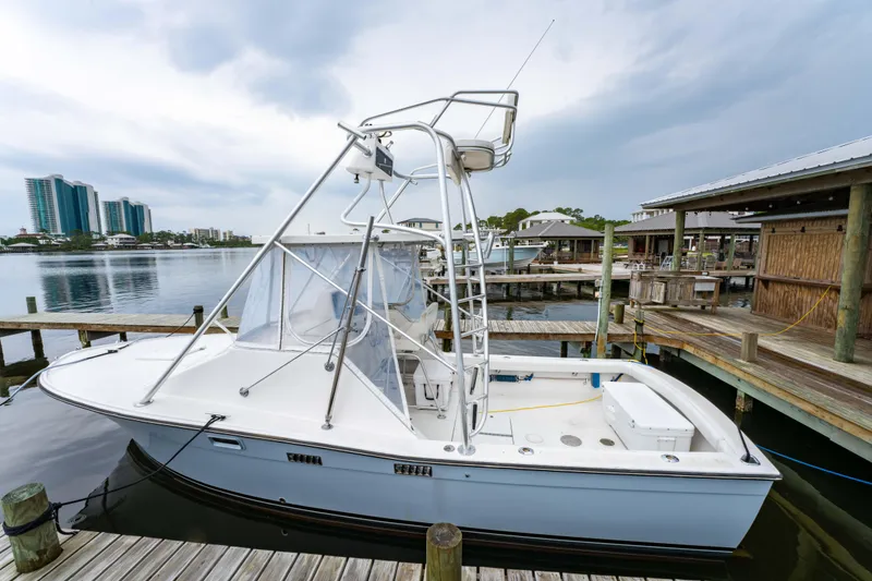 Slide: The Image of 1978 Topaz 28 boat docked at marina with overcast sky. - 6