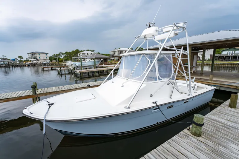 Slide: The Image of 1978 Topaz 28 boat docked at marina under cloudy sky. - 7