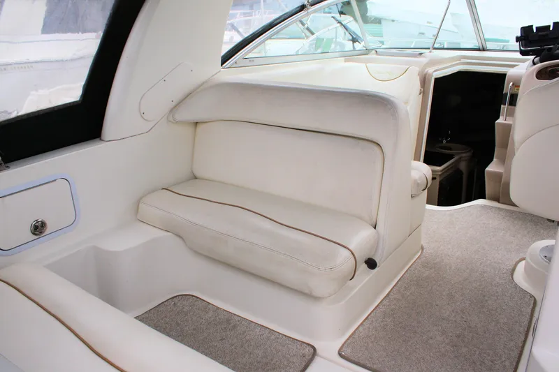 Slide: The Image of 2003 Sea Ray 260 Sundancer interior with white seating and carpeted flooring. - 10