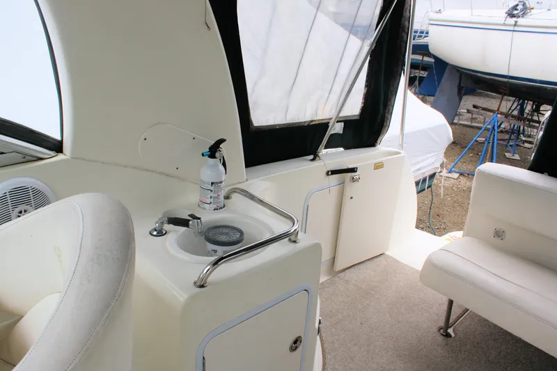 Slide: The Image of 2003 Sea Ray 260 Sundancer interior with sink and seating area. - 14