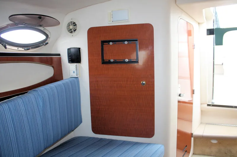 Slide: The Image of Interior of 2003 Sea Ray 260 Sundancer with blue seating and wooden accents. - 17