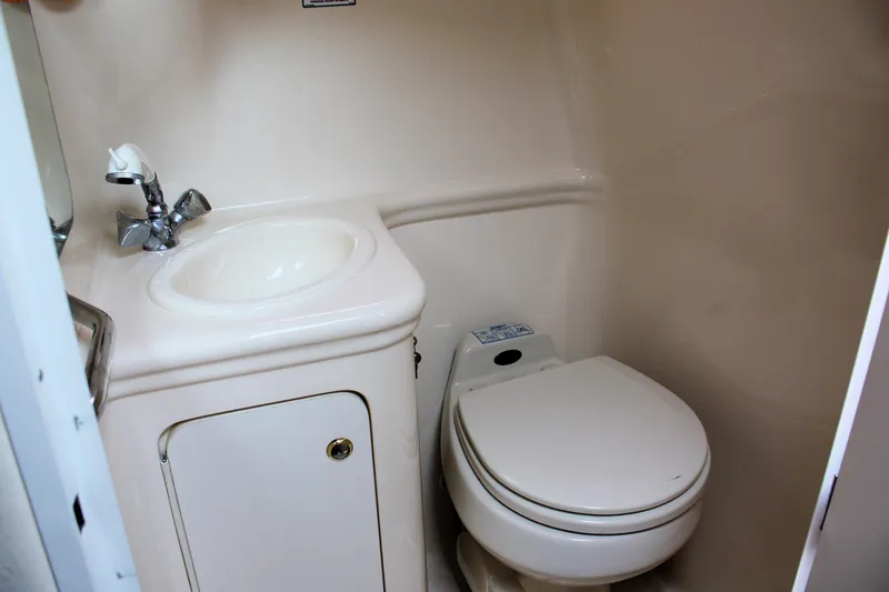 Slide: The Image of Compact bathroom in 2003 Sea Ray 260 Sundancer with sink and toilet. - 22