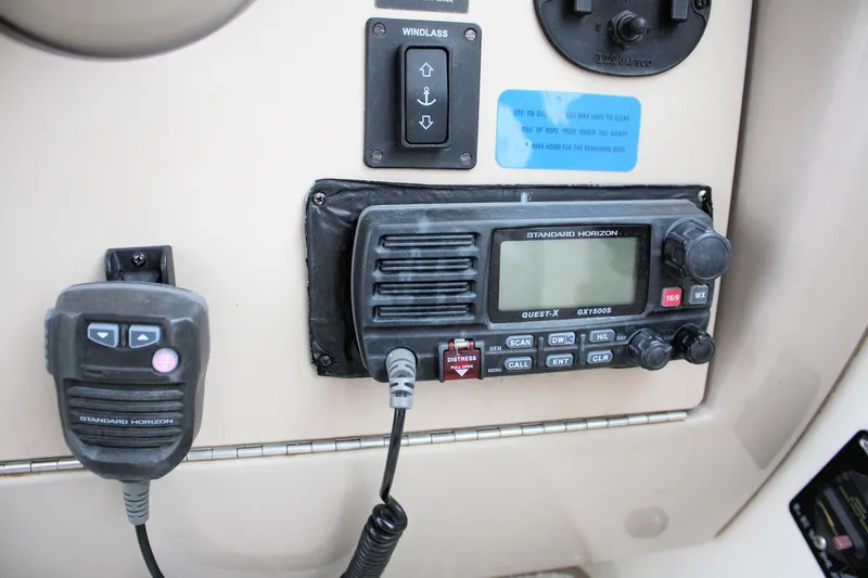 Slide: The Image of Control panel of a 2003 Sea Ray 260 Sundancer boat with radio and microphone. - 24