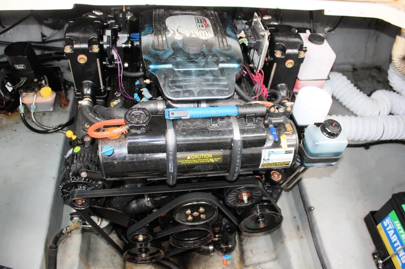 Slide: The Image of Engine compartment of a 2003 Sea Ray 260 Sundancer boat, showcasing mechanical components. - 27