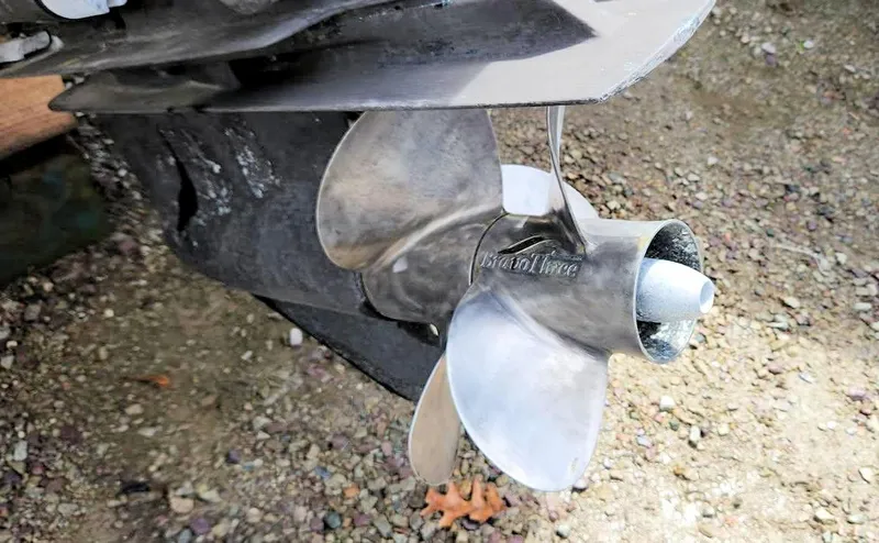 Slide: The Image of Propeller of 2003 Sea Ray 260 Sundancer boat on gravel surface. - 30
