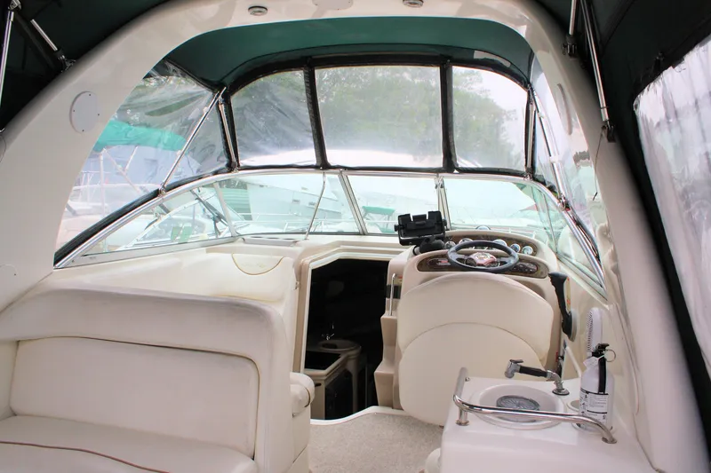 Slide: The Image of 2003 Sea Ray 260 Sundancer boat interior with helm, seating, and dashboard. - 6