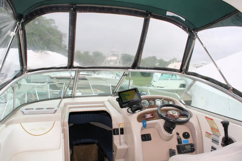 Slide: The Image of 2003 Sea Ray 260 Sundancer boat interior with steering wheel and navigation equipment. - 7