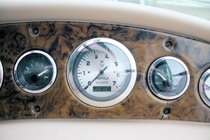 Slide: The Image of Dashboard of 2003 Sea Ray 260 Sundancer boat with RPM and fuel gauges. - 9