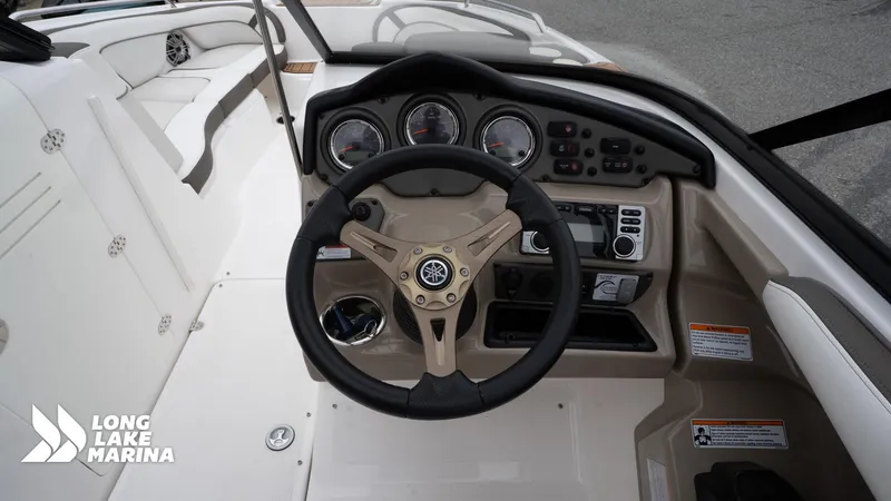Slide: The Image of 2014 Yamaha Boats 242 Limited S dashboard with steering wheel and controls at Long Lake Marina. - 16