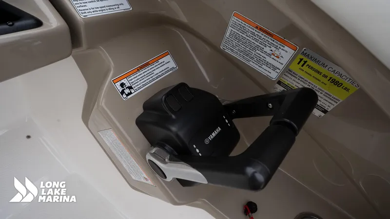 Slide: The Image of Control panel of 2014 Yamaha Boats 242 Limited S with capacity warnings and throttle lever. - 21
