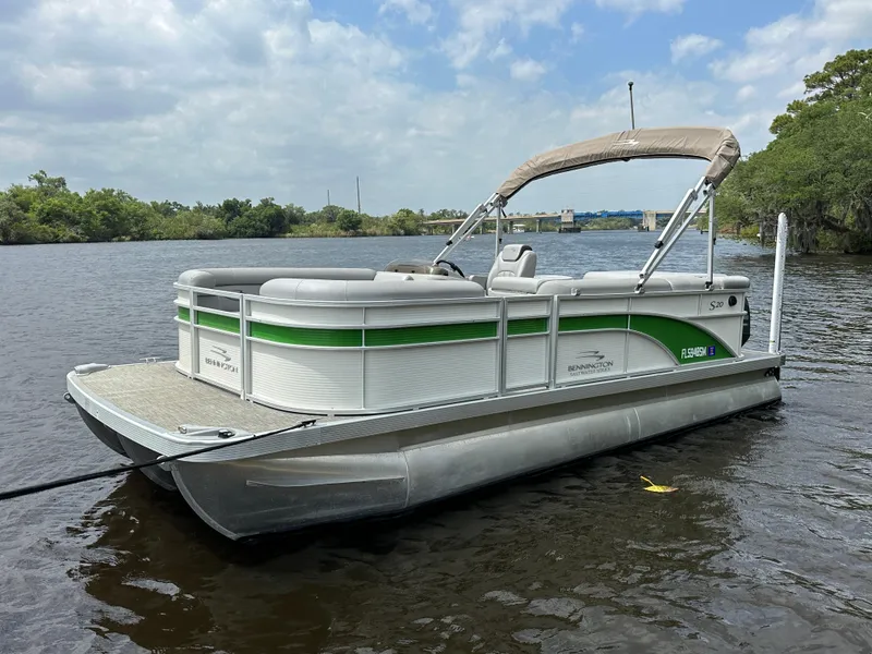 Slide: The Image of 2020 Bennington S 20 SLL pontoon boat on a calm river. - 1