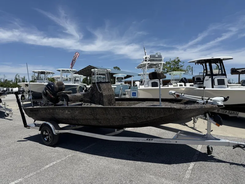 Slide: The Image of 2025 Xpress Hyper-Lift H190 Bay Series boat on trailer in marina parking lot. - 1