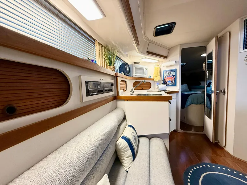 Slide: The Image of Interior of 1988 Carver Montego 3257 yacht, featuring cozy seating and modern amenities. - 31