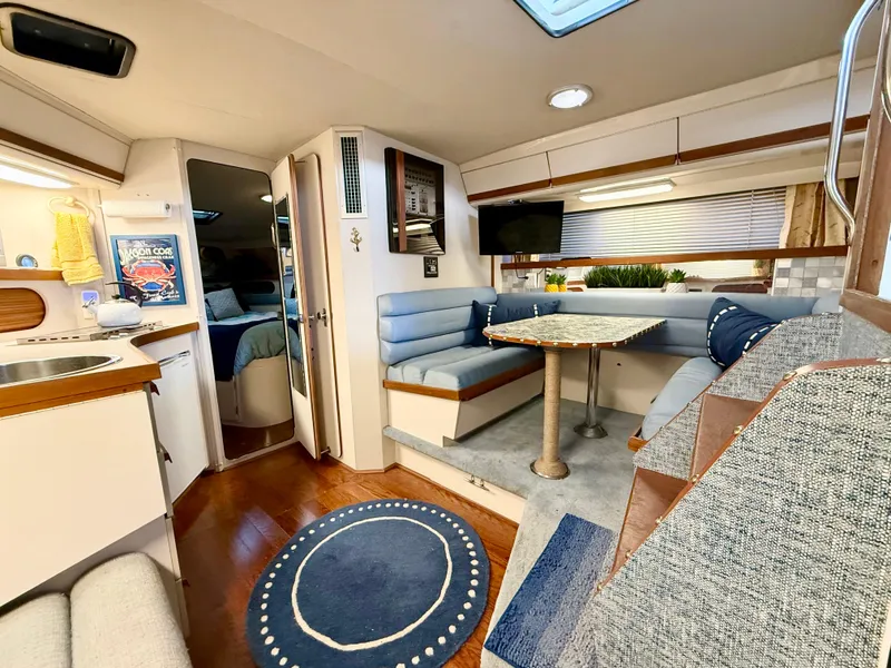 Slide: The Image of Interior of 1988 Carver Montego 3257 yacht with cozy seating and dining area. - 32