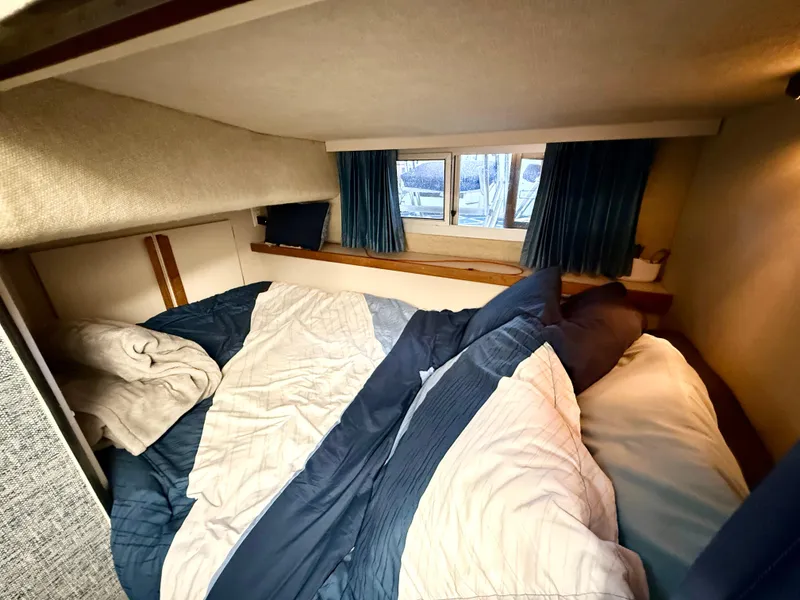 Slide: The Image of Cozy cabin interior of 1988 Carver Montego 3257 with bed and window view. - 33