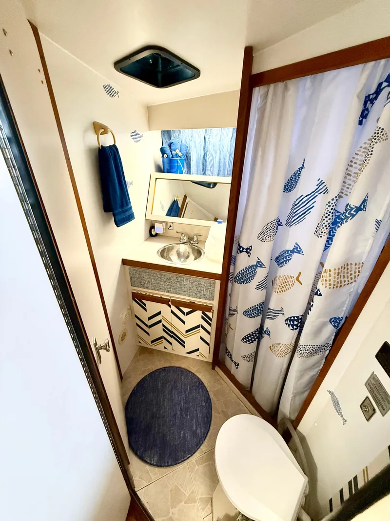 Slide: The Image of 1988 Carver Montego 3257 bathroom with nautical decor, featuring fish-patterned shower curtain. - 35