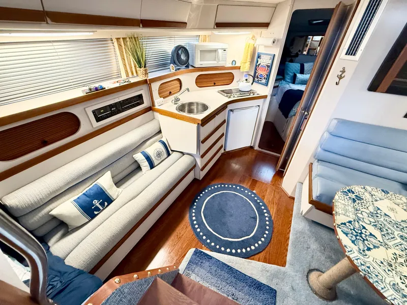Slide: The Image of Interior of a 1988 Carver Montego 3257 yacht with cozy seating and kitchenette. - 44