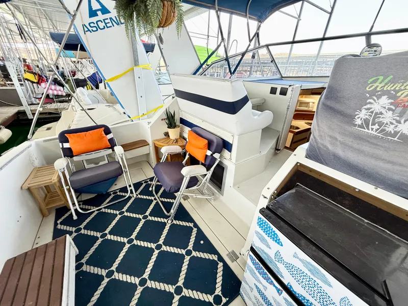 Slide: The Image of 1988 Carver Montego 3257 boat interior with seating, nautical decor, and helm station. - 46