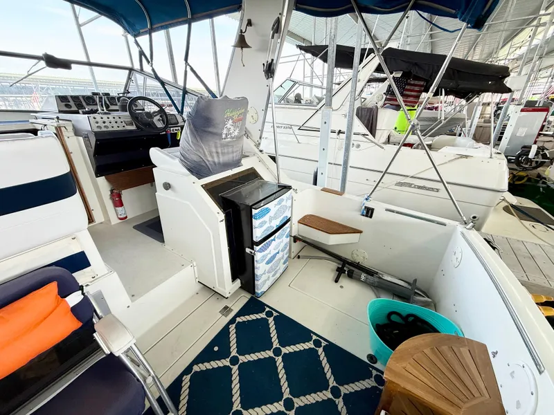 Slide: The Image of 1988 Carver Montego 3257 boat interior with helm, seating, and nautical decor. - 47