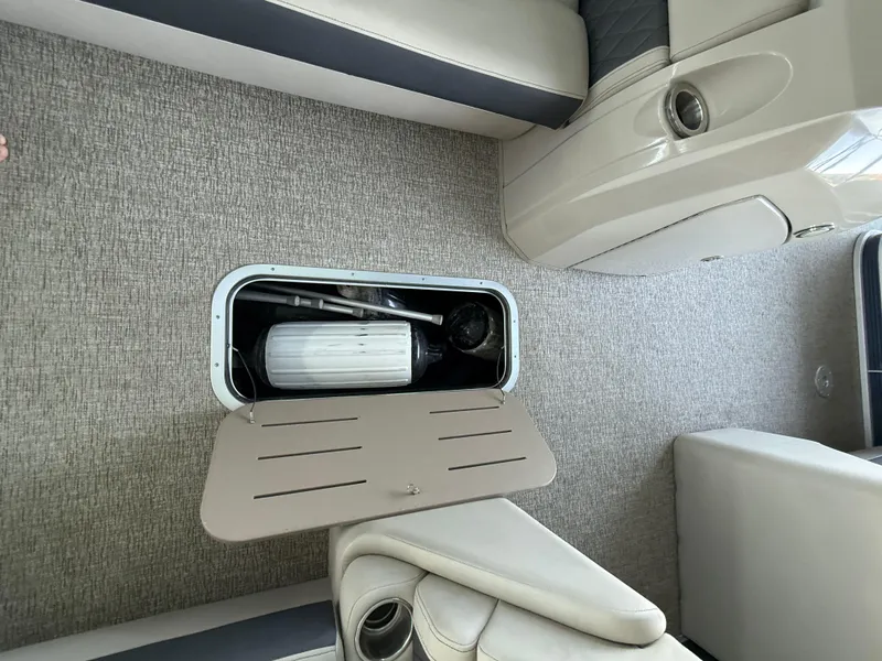 Slide: The Image of Storage compartment in 2019 Bennington SX 25 Premium Swingback boat interior. - 11