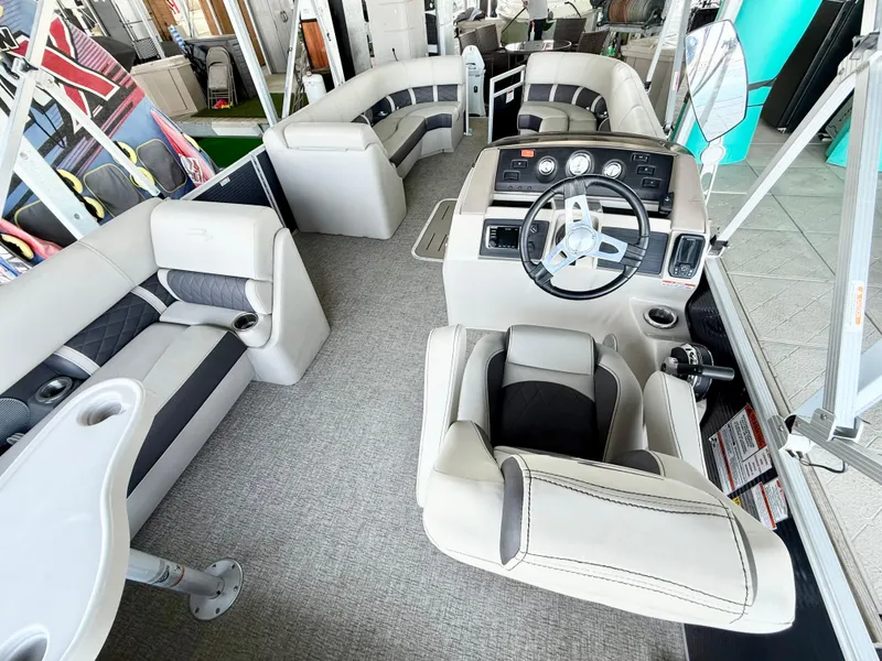 Slide: The Image of 2019 Bennington SX 25 Premium Swingback interior with plush seating and modern helm. - 12
