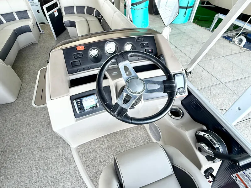 Slide: The Image of 2019 Bennington SX 25 Premium Swingback boat interior with steering wheel and dashboard controls. - 15