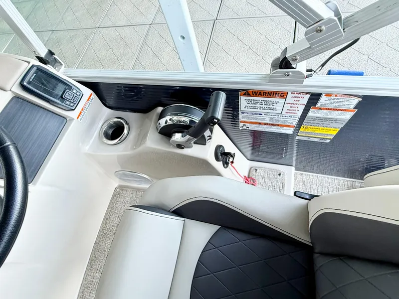 Slide: The Image of 2019 Bennington SX 25 Premium Swingback boat interior with control panel and seating. - 16