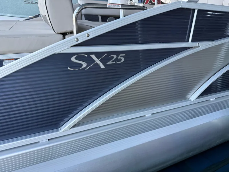 Slide: The Image of 2019 Bennington SX 25 Premium Swingback pontoon boat, side view with logo detail. - 20
