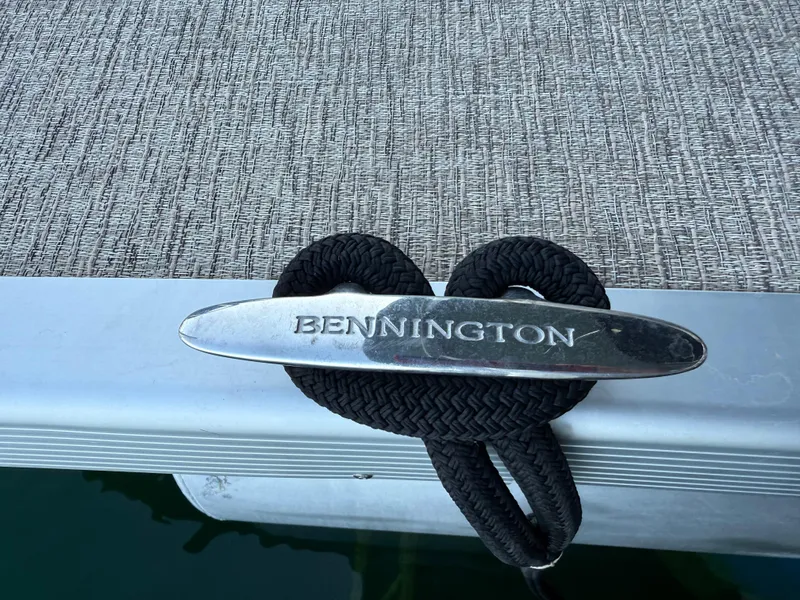Slide: The Image of Bennington SX 25 Premium Swingback 2019 boat cleat with rope on deck. - 21