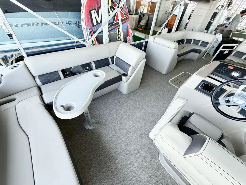 Slide: The Image of 2019 Bennington SX 25 Premium Swingback interior with plush seating and modern helm. - 9