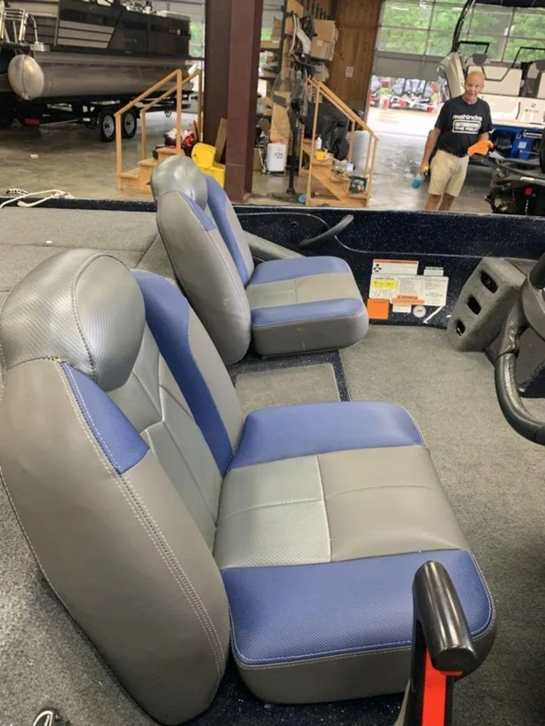 Slide: The Image of 2020 Skeeter ZX190 boat interior with blue and gray seats in a garage setting. - 3