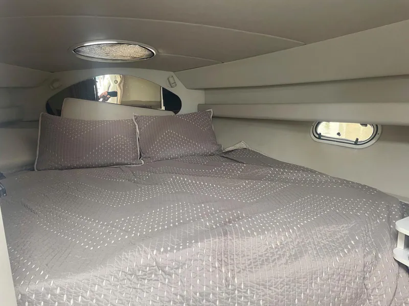 Slide: The Image of Interior cabin of 1998 Cruisers Yachts 3375 Esprit with cozy bed and porthole window. - 14