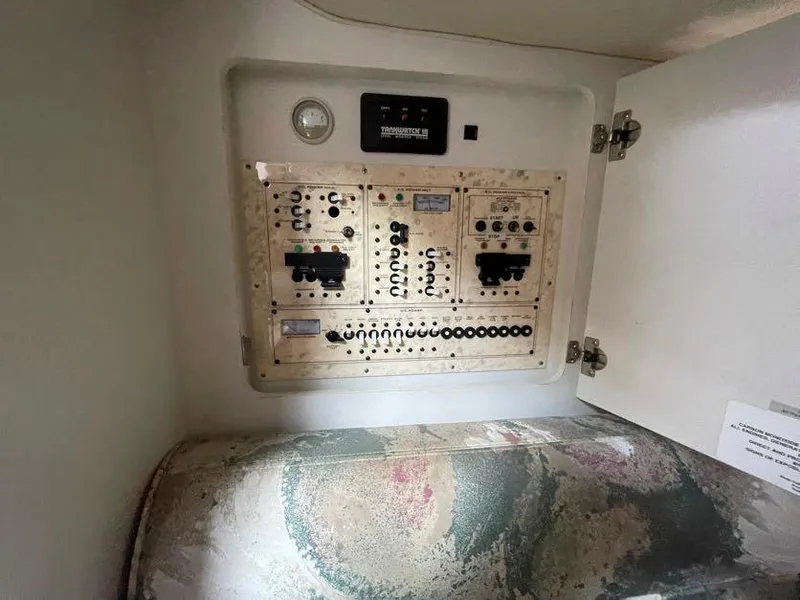 Slide: The Image of Electrical panel inside 1998 Cruisers Yachts 3375 Esprit, with open cabinet door. - 17