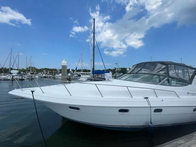 Slide: The Image of 1998 Cruisers Yachts 3375 Esprit docked at marina under blue sky. - 2